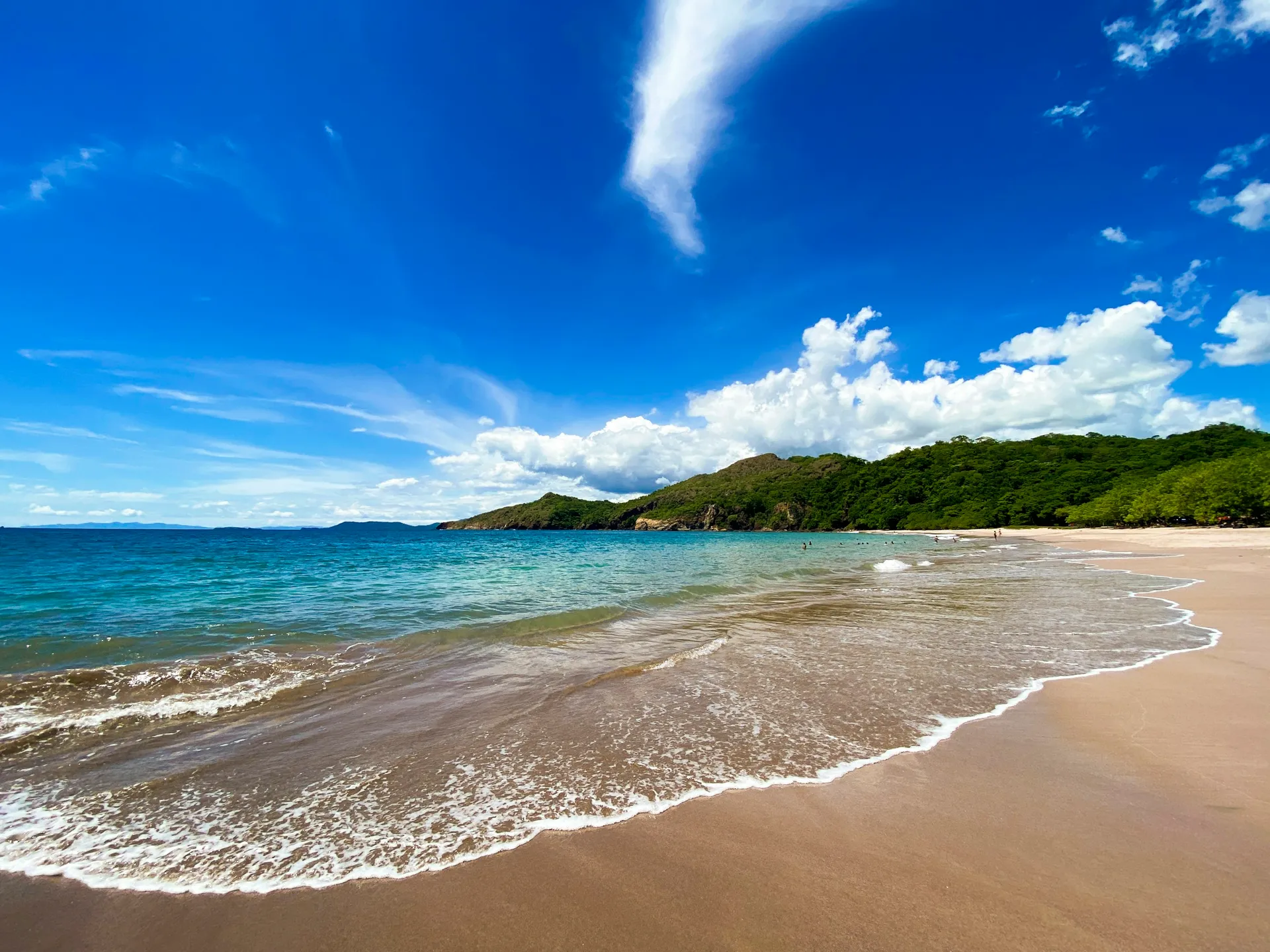 A wide Pacific beach and green headland on Costa Rica's Guanacaste coast