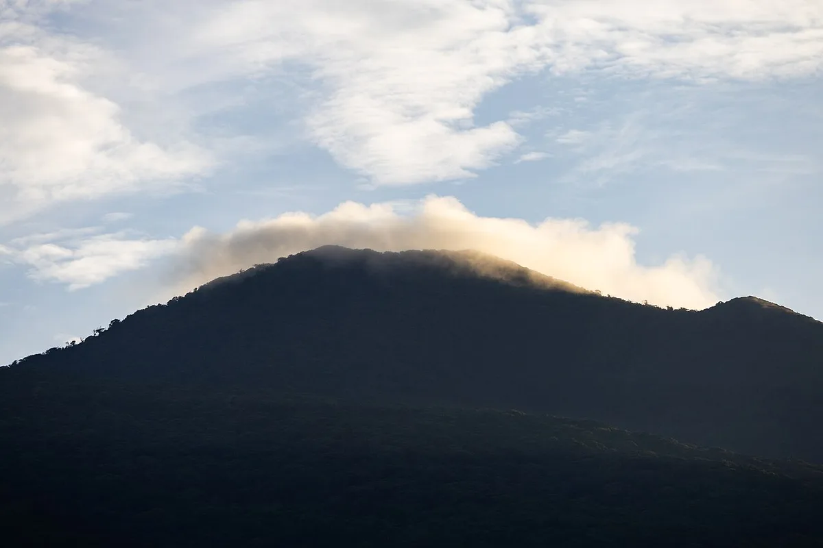 Cloud drifting over the forested summit of Rincón de la Vieja volcano in Guanacaste, Costa Rica