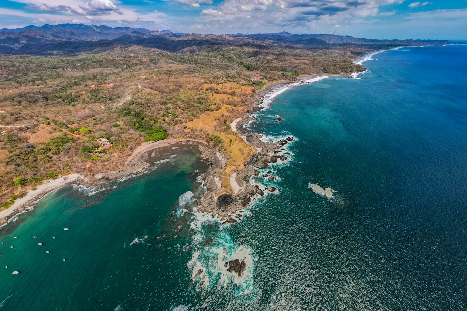Aerial view of Guanacaste's dry-forest coastline with rocky points and small coves