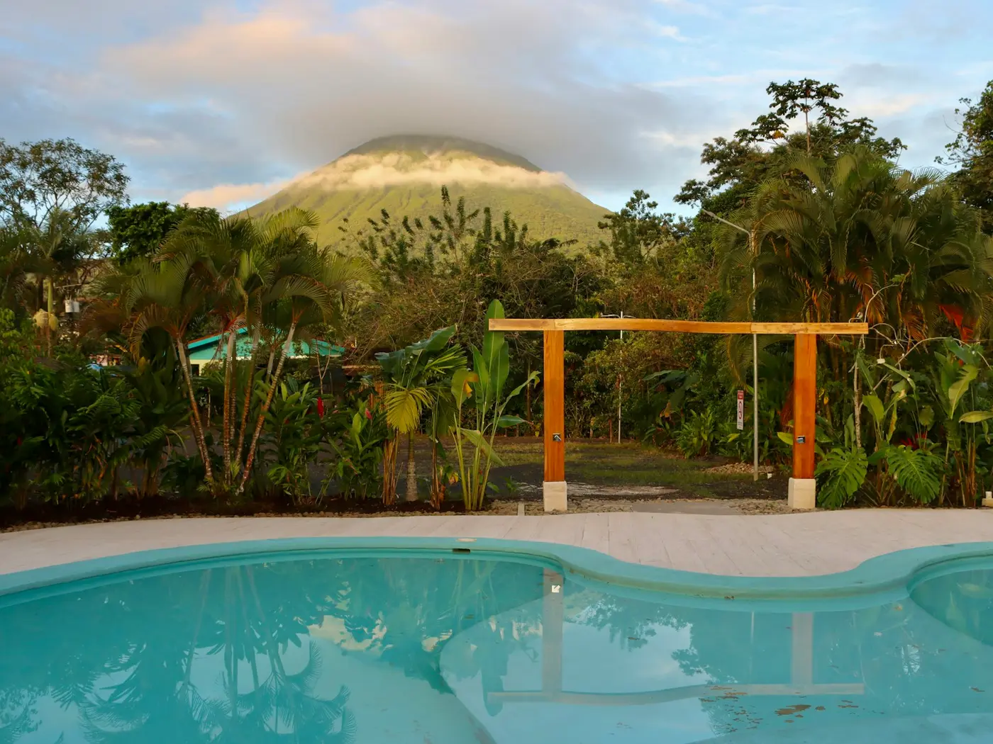 A pool facing the cone of Arenal volcano at dusk near La Fortuna, Costa Rica
